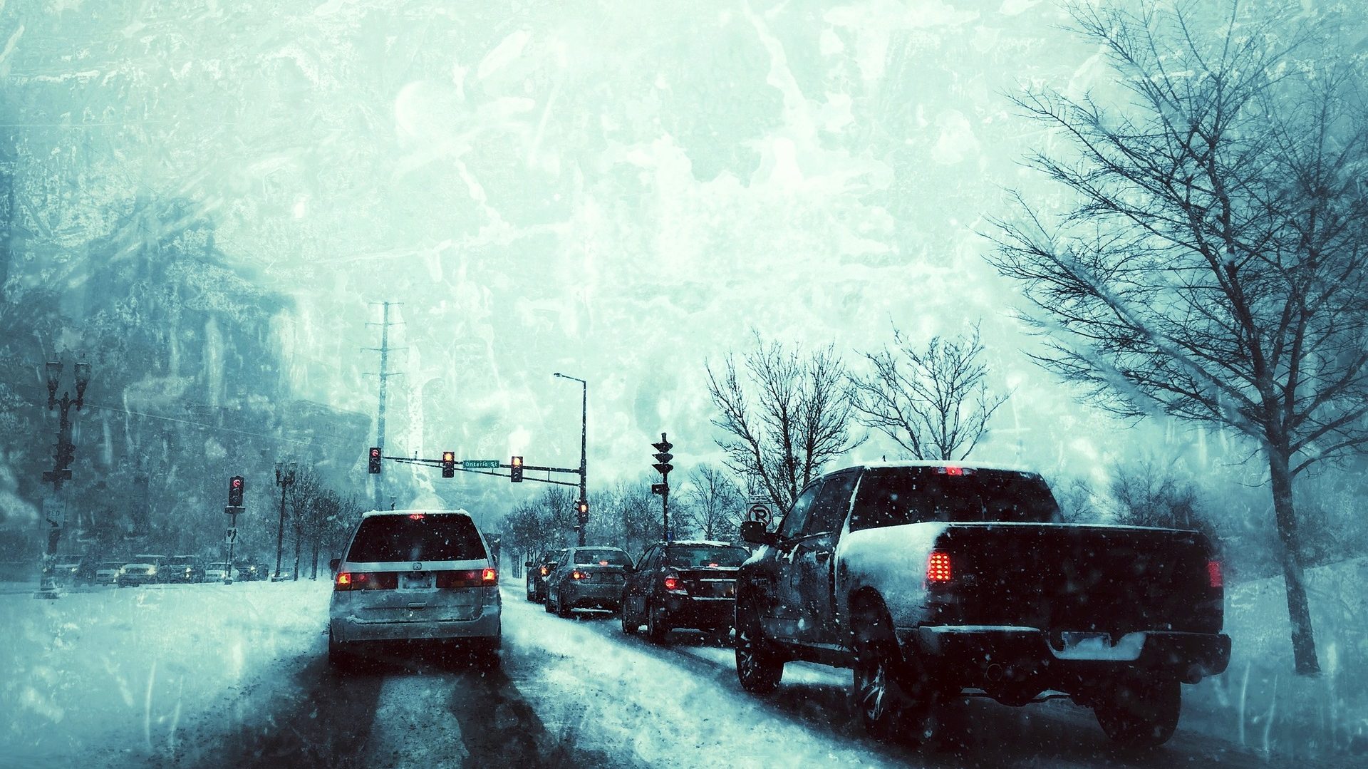 a photo of cars driving on snowy roads