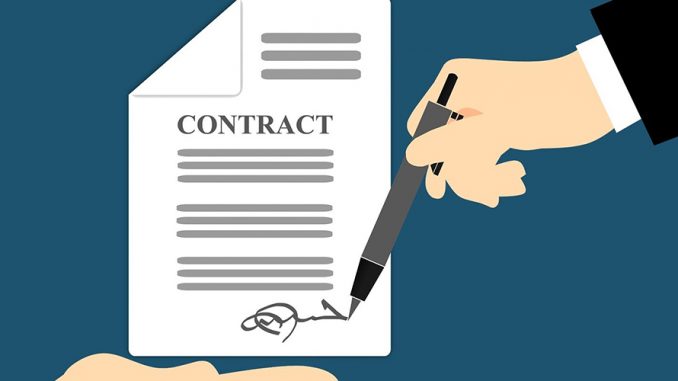 image of two hands signing a contract